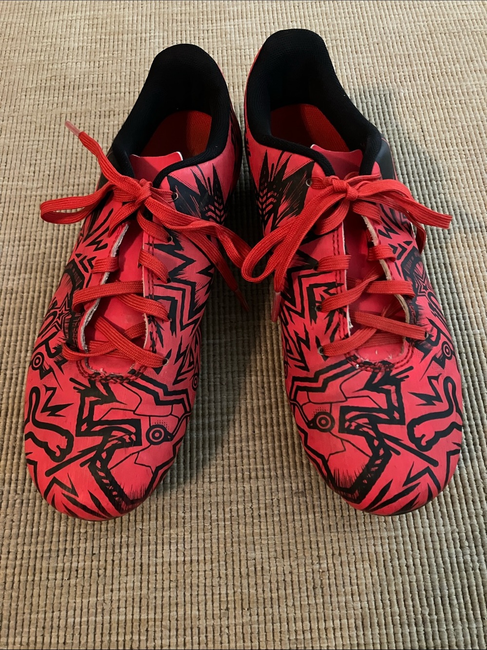Red and black Puma kids cleats